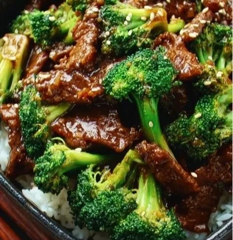 Delicious plate of Chinese beef and broccoli stir-fry on a wooden table