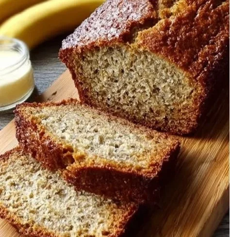 A slice of homemade easy banana bread displayed on a wooden table.