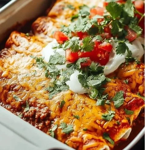 Delicious easy ground beef enchiladas topped with cheese and sauce
