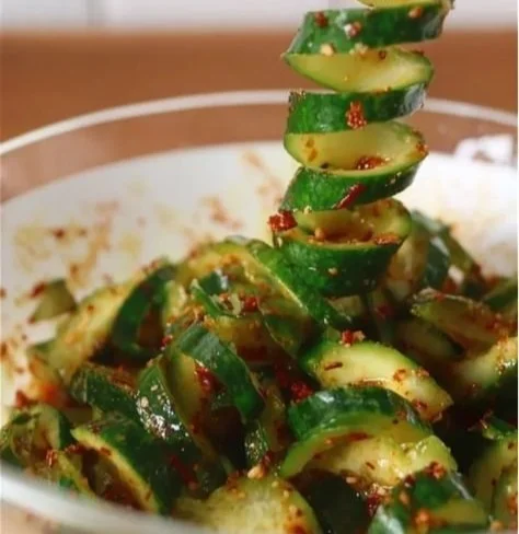 Delicious Korean Cucumber Salad on a plate with sesame seeds and herbs