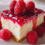 Delicious homemade raspberry cheesecake topped with fresh raspberries