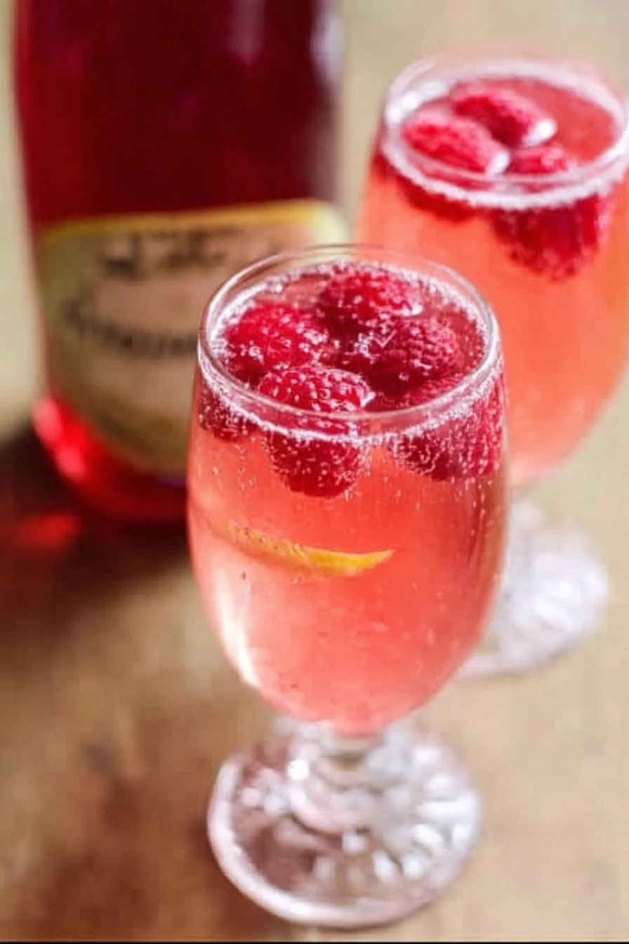 Charming Raspberry Limoncello Prosecco cocktail served in a glass with raspberries
