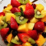 A colorful bowl of fresh fruit salad with a variety of fruits