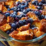 Delicious blueberry french toast casserole topped with fresh blueberries and syrup